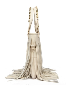 Detail of beige tassel handbag featuring gold braided handles and side D-ring buckle