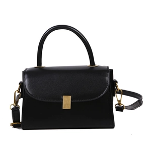 Minimalist black crossbody bag with curved top handle and gold metal buckle detail