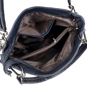Internal view of navy crossbody bag showing multiple compartments and durable brown lining