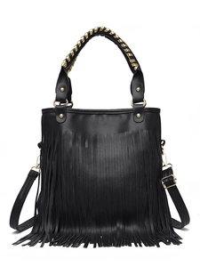 Detail of black tassel handbag with gold chain handle and lychee pattern leather