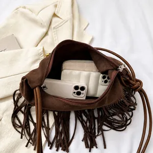 Interior view of brown suede tassel shoulder bag showing spacious storage capacity