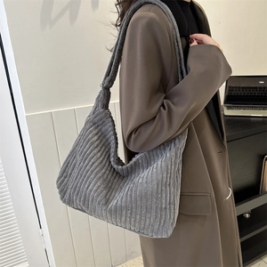 Detailed texture of grey corduroy hobo bag featuring wide shoulder strap for women