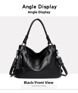 Front view of black pebble faux leather tote bag with V-shaped stitching and tassel detail