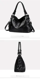 Detail of black faux leather tote bag with V-shaped stitching and tassel pendant charm