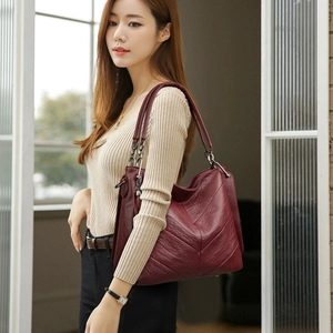 Burgundy textured leather tote bag with V-stitching and gunmetal hardware for women