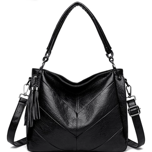 Quilted black leather crossbody bag with V-stitch pattern and decorative fringe tassel