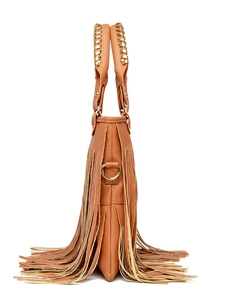 Detail view of brown leather handbag featuring long tassels and gold metallic hardware