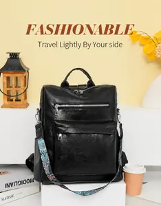 Close-up of black textured leather backpack with ethnic embroidery strap and silver zippers