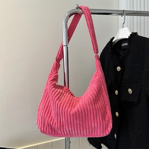 Detail of soft bright pink corduroy fabric and wide strap on large tote bag