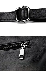 Close-up of silver metal buckle and zipper on black litchi texture PU leather tote