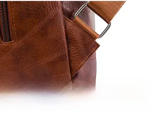 Macro shot of reinforced triangular stitching on vintage brown faux leather backpack