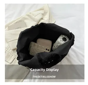 Detail showing the large interior capacity of this black pleated floral tote bag