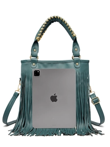 Detail of teal fringe handbag showing storage capacity next to an 11 inch tablet