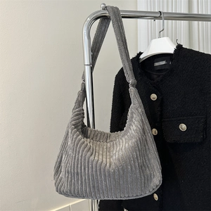 Detailed texture of grey corduroy tote bag showing vertical stripes and soft fabric