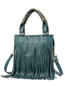 Detail of dark green fringe handbag with woven gold metal handle and long tassels
