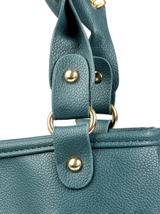 Detail of dark teal pebble leather handbag with gold metal ring and handle stitching
