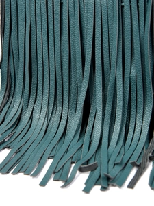 Close-up of deep teal leather tassel detail with high-quality pebbled texture on handbag