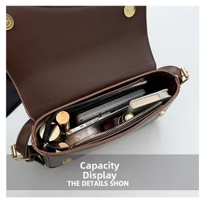 Interior storage space of the brown leather shoulder bag with multiple compartments