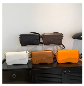 Collection of minimalist flap crossbody bags with wavy edge design in multiple colors