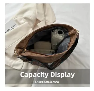Interior capacity of vintage bucket bag showing umbrella and phone on white background
