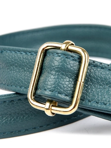 Detailed close-up of dark green litchi grain leather strap with golden metal buckle