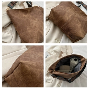 Detail showing the brown bucket bag ethnic strap, stitching and spacious interior