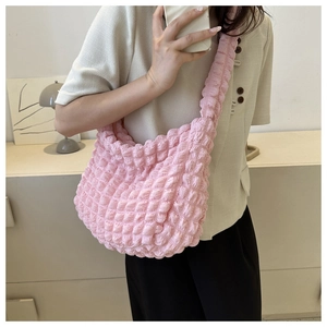 Detail shot of pink cloud bag showing 3D bubble texture and soft polyester fabric