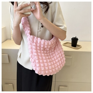 Detail of pink bubble texture shoulder bag with light polyester fabric on model