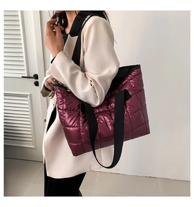 Quilted tote bag in metallic purple finish styled with a white blazer for casual outfits
