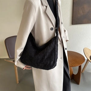 Large black corduroy hobo tote bag for women shown as a stylish crossbody bag