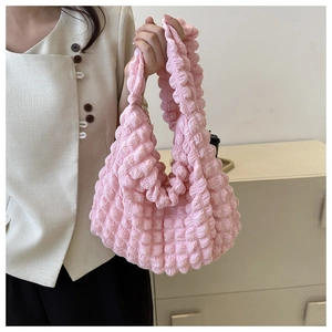 Detail of pink cloud-shaped pleats on the shoulder bag showing bubble texture and zipper