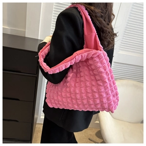 Detail of bright pink tote bag featuring unique bubble pleated texture and large capacity