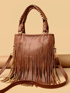 Detail of brown faux leather handbag featuring long tassels and woven rivet handle