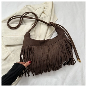 Detail of dark brown suede tassel bag with high-quality bohemian fringe texture