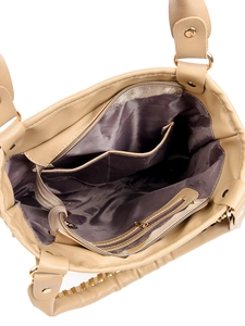 Detailed interior view of beige handbag showing pockets and smooth lining texture