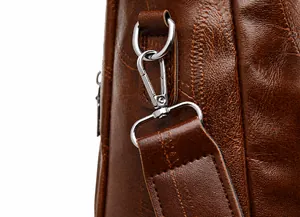 Detail of dark brown vintage leather texture with silver metal hook and D-ring buckle