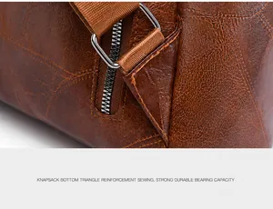 Detail of triangular reinforced stitching on brown leather backpack with silver hardware