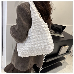 Detailed texture of white bubble fabric on a minimalist shoulder tote bag for women