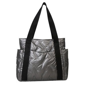 Metallic silver quilted puffer tote bag with black nylon straps and side pockets