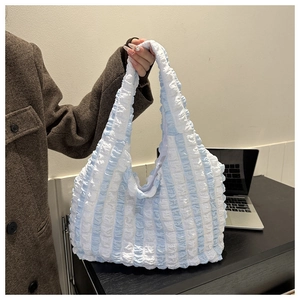 Detail of blue and white striped bubble texture tote bag showing soft popcorn fabric