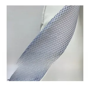 Detailed macro view of the grey breathable mesh shoulder strap with honeycomb structure