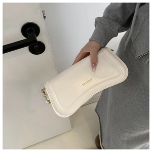 Detail of off-white faux leather shoulder bag with gold chain strap and brand logo