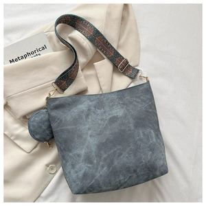 Detail view of retro gray bucket bag with bohemian patterned jacquard wide strap