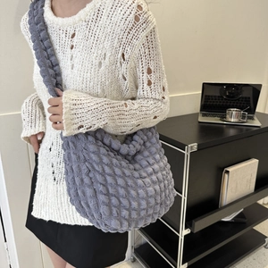 Blue-grey bubble textured cloud bag styled with white knit sweater for daily commute