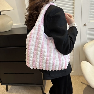 Pink and white striped bubble plissé tote bag showing large capacity and shoulder style