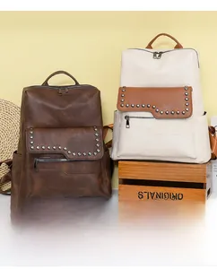Detail view of vintage faux leather backpacks with metal studs and smooth zippers