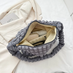 Interior view showing large storage capacity for phone and wallet in grey bubble bag