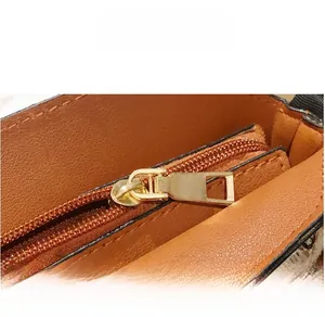 Detail of premium gold metal zipper and leather texture on a woven bucket bag