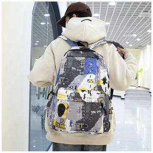 Rear view of a model wearing a graffiti print backpack in blue and yellow street style