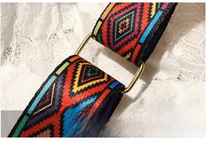 Close-up of colorful geometric woven shoulder strap with gold metal buckle detail